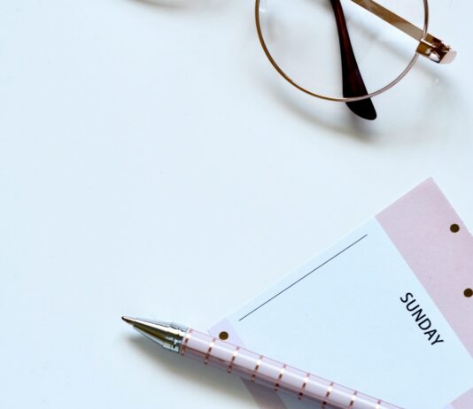 근육량 증대를 위한 운동과 영양 조절 eyeglasses near paper and ballpoint pen