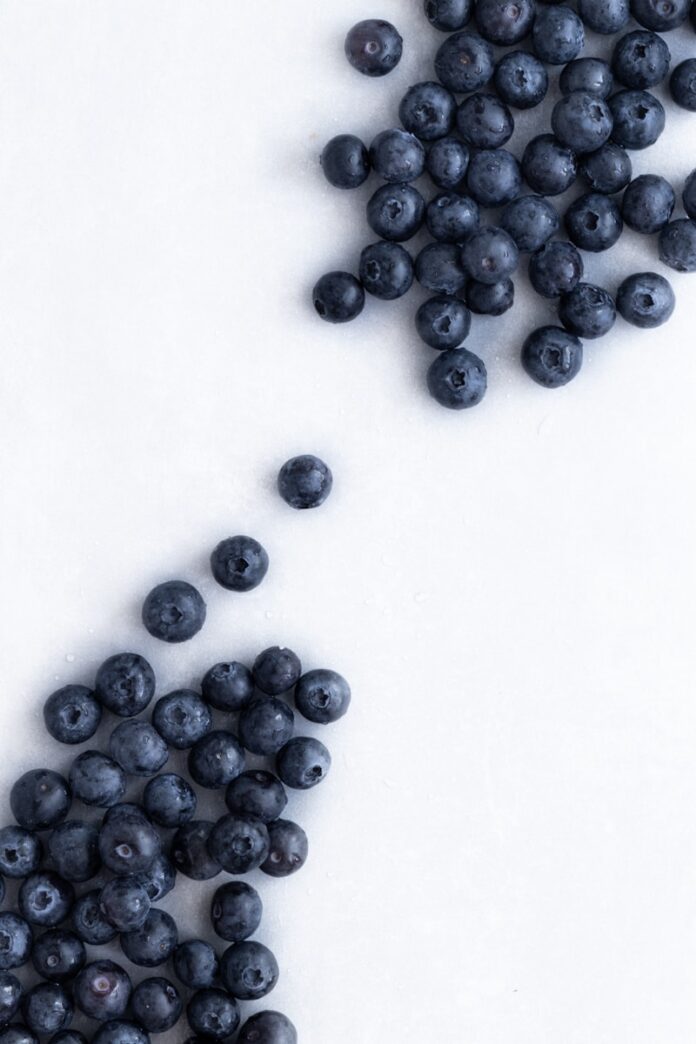 blue berries on white surface
