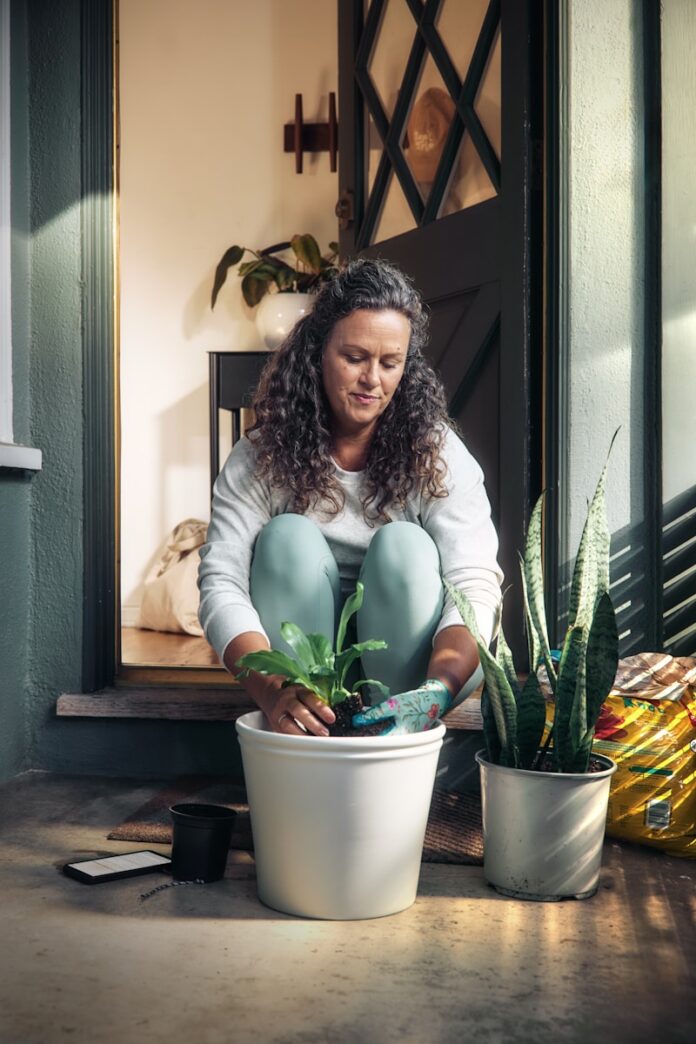 Photo by Microsoft Copilot Woman potting a plant on a porch