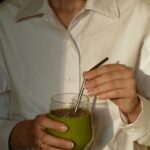 일상 속 웰니스, 새로운 트렌드와 실천 방법 person in white button up shirt holding clear drinking glass with green liquid